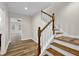 View of a staircase with wooden handrail and white risers at 9562 N Gasburg Rd, Mooresville, IN 46158