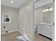 Laundry and bathroom with white vanity and tile floor at 9562 N Gasburg Rd, Mooresville, IN 46158