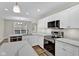 Modern kitchen with white cabinets, stainless steel appliances, and quartz countertops at 9562 N Gasburg Rd, Mooresville, IN 46158