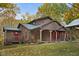 Charming brown house exterior with red doors and porch at 9562 N Gasburg Rd, Mooresville, IN 46158