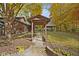 Stone pathway leads to a charming covered walkway in a tree-filled backyard at 9562 N Gasburg Rd, Mooresville, IN 46158