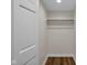Walk-in closet with wood flooring and hanging rod at 9562 N Gasburg Rd, Mooresville, IN 46158