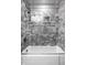 Clean bathroom with a shower/tub combo and marble tile at 235 Pine Dr, Indianapolis, IN 46260