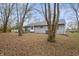 Backyard view of house with patio and trees at 5346 Shefford Ct, Indianapolis, IN 46254