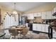 Kitchen boasts white cabinets, black appliances, and a breakfast nook at 5346 Shefford Ct, Indianapolis, IN 46254