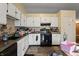 Kitchen with white cabinets, black appliances, and ample counter space at 5346 Shefford Ct, Indianapolis, IN 46254