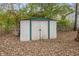 White metal storage shed with green trim in backyard at 5346 Shefford Ct, Indianapolis, IN 46254