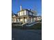 Two-story white brick home with a wraparound porch and landscaped yard at 201 W Walnut St, Waldron, IN 46182