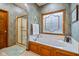 Bathroom boasts a soaking tub, walk-in shower, and stained glass window at 1079 Old Eagle Way, Greenwood, IN 46143