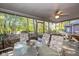 Relaxing screened porch with outdoor furniture and wooded views at 1079 Old Eagle Way, Greenwood, IN 46143