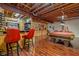 Basement with a bar, pool table, and wood flooring at 1079 Old Eagle Way, Greenwood, IN 46143
