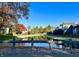 Community features pond with autumn foliage and homes at 4720 Stoughton Ct, Indianapolis, IN 46254