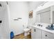 Modern bathroom with white vanity, shower, and wood-look floors at 318 N Tacoma Ave, Indianapolis, IN 46201