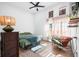 Relaxing bedroom with a green duvet, comfortable armchair, and hardwood floors at 318 N Tacoma Ave, Indianapolis, IN 46201