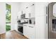 Modern kitchen with white cabinets, stainless steel appliances, and wood flooring at 318 N Tacoma Ave, Indianapolis, IN 46201