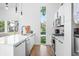White kitchen features stainless steel appliances and a farmhouse sink at 318 N Tacoma Ave, Indianapolis, IN 46201
