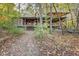 Rustic cabin nestled in the woods with a wraparound porch at 3708 State Ferry Rd, Solsberry, IN 47459