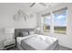Bright bedroom with gray bedding and large windows at 802 Weldon Way, Westfield, IN 46074
