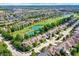 Luxury homes with brown roofs near a golf course and pond at 15571 Bridgewater Club Blvd, Carmel, IN 46033