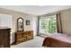Bright bedroom with large window, dresser and a double bed at 15571 Bridgewater Club Blvd, Carmel, IN 46033