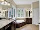 Spacious bathroom with double vanity, large soaking tub, and tile flooring at 15571 Bridgewater Club Blvd, Carmel, IN 46033