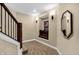 Basement hallway with window seat and mirror at 15571 Bridgewater Club Blvd, Carmel, IN 46033