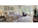 Spacious bedroom with bay window, large bed, and relaxing seating area at 15571 Bridgewater Club Blvd, Carmel, IN 46033