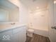 Clean bathroom with a bathtub, toilet, and vanity at 6105 Card Blvd, Indianapolis, IN 46221