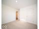 Simple bedroom with carpeted floor and an additional doorway at 6105 Card Blvd, Indianapolis, IN 46221
