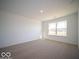 Spacious bedroom with large window and neutral carpeting at 6105 Card Blvd, Indianapolis, IN 46221
