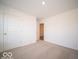Simple bedroom with carpeted floor and an additional doorway at 6105 Card Blvd, Indianapolis, IN 46221