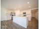 Modern kitchen with white cabinets and an island at 6105 Card Blvd, Indianapolis, IN 46221
