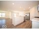 Modern kitchen with island, stainless steel appliances, and vinyl flooring at 6105 Card Blvd, Indianapolis, IN 46221