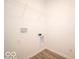 Bright laundry room with built-in shelving and vinyl flooring at 6105 Card Blvd, Indianapolis, IN 46221