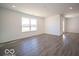 Open living area with vinyl flooring and a large window at 6105 Card Blvd, Indianapolis, IN 46221