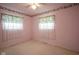 Bedroom with pink walls, floral border, and ceiling fan at 216 E Elm St, Jamestown, IN 46147