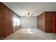 Bright living room with wood paneling and ceiling fan at 216 E Elm St, Jamestown, IN 46147