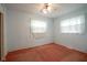 Simple bedroom with two windows, ceiling fan, and orange carpet at 216 E Elm St, Jamestown, IN 46147