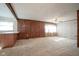 Spacious living room featuring wood paneling and brick accent wall at 216 E Elm St, Jamestown, IN 46147