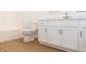 Main bathroom includes toilet, vanity, and hardwood floor at 4407 W Wandalee Ct, New Palestine, IN 46163