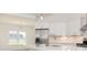 White kitchen with stainless steel appliances and a large window at 4407 W Wandalee Ct, New Palestine, IN 46163