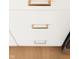 Close-up of white kitchen cabinets with modern gold handles at 4407 W Wandalee Ct, New Palestine, IN 46163