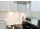 Kitchen features white cabinets, quartz countertop, and stainless steel range at 4407 W Wandalee Ct, New Palestine, IN 46163