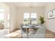 Modern dining room with large windows and table setting at 4407 W Wandalee Ct, New Palestine, IN 46163