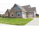 Side view of home showcasing garage at 4407 W Wandalee Ct, New Palestine, IN 46163