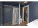 Bathroom with dark tile shower, white vanity, and in-unit laundry at 108 E St Clair St # B, Indianapolis, IN 46204
