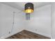 Bright bedroom with wood-look flooring, large closet, and modern light fixture at 108 E St Clair St # B, Indianapolis, IN 46204