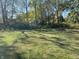 Large grassy backyard with mature trees at 647 W Mcgregor Rd, Indianapolis, IN 46217