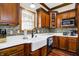 Modern kitchen with white quartz countertops and dark wood cabinets at 7178 Lockford N, Avon, IN 46123