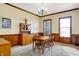 Formal dining room with a wooden table, hutch, and wood-paneled walls at 7178 Lockford N, Avon, IN 46123